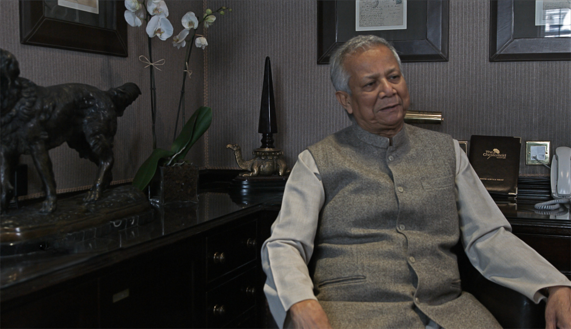 Muhammad Yunus Disparity film still, Muhammad Yunus sitting