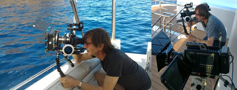 Kane Kramer with camera filming on boat